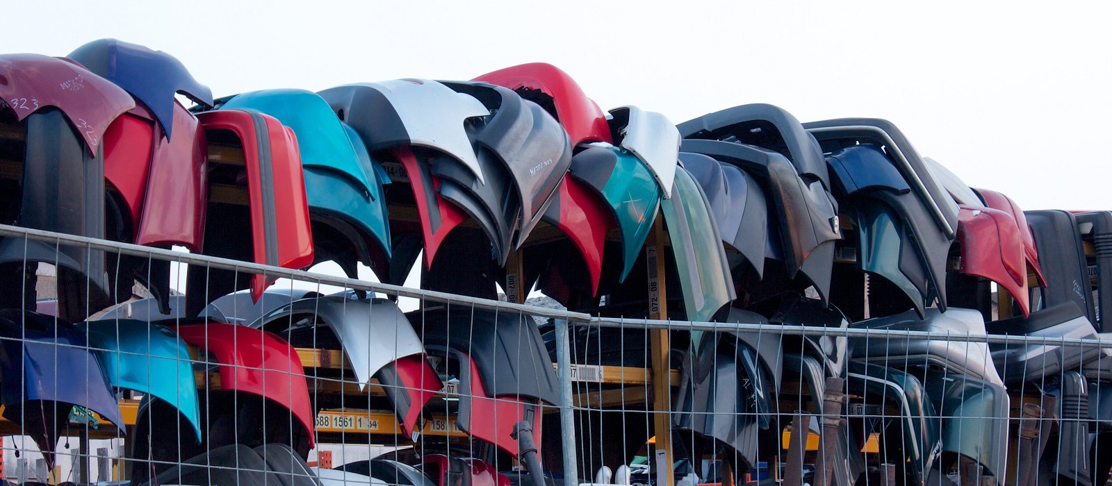Used car fenders on a rack, waiting to be re-used for accident cars
